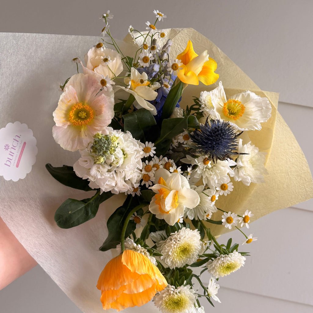 Sun Butter bunch, golden yellow and cream flowers with a hint of sky blue
